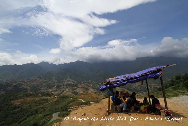 A make shift shelter with ethnic minorities selling handicrafts. At this place we left the main road and rode down into the village below.