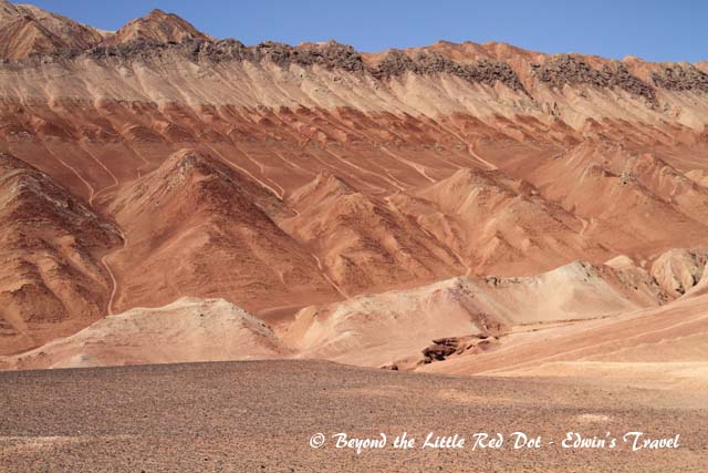 The mountains are colorful with many distinct layers of rock, sandstone, and sand.