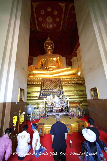 A large golden Buddha sits inside.
