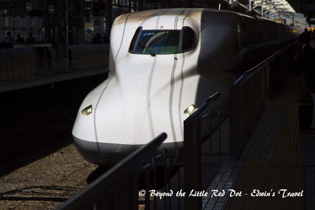 A Shinkansen train pulling into the station.