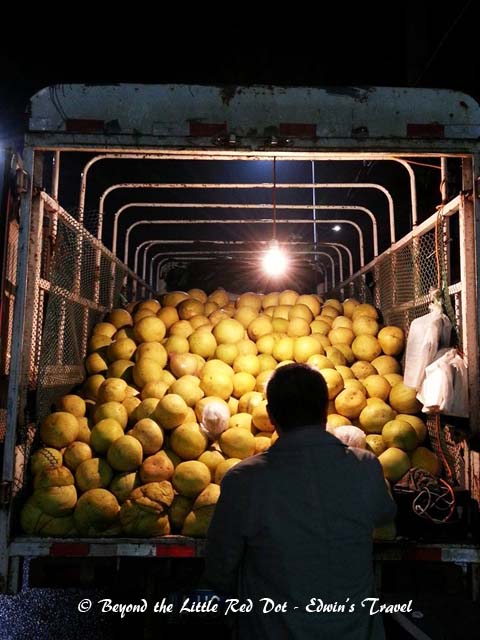 With the bad weather, we decided to go back to our hotel. Here we are, buying melons from the back of a truck on the road side.