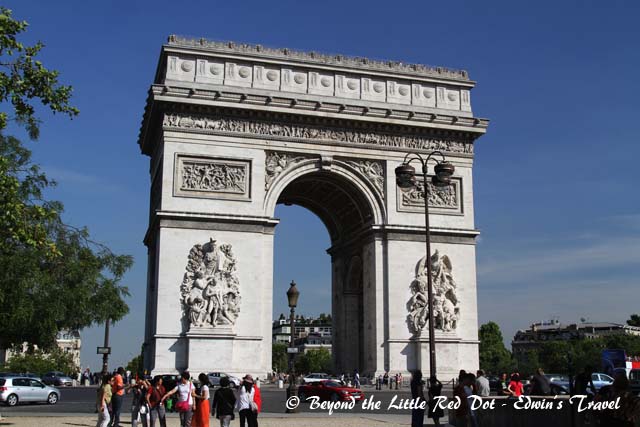 The Arc de Triomphe. It honours those who fought and died for France in the French Revolutionary and the Napoleonic Wars, with the names of all French victories and generals inscribed on its inner and outer surfaces. Beneath its vault lies the Tomb of the Unknown Soldier from World War I.