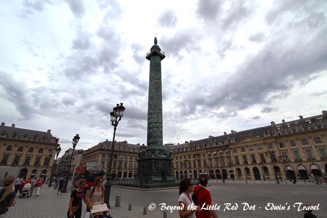 The square of Place Vendome and the Vendome Column with a statue of Napoléon at its top.