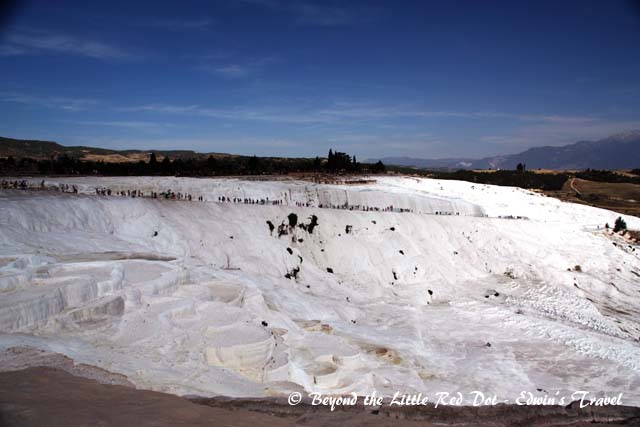 The terraces are natural and formed from travertine, a type of rock that is deposited by the hot springs.