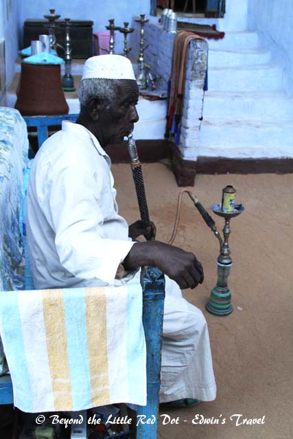 Grandpa having a smoke on the shisha pipe.