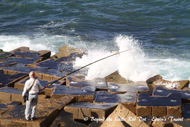 Fishing by the fort on the Mediterranean Sea. 