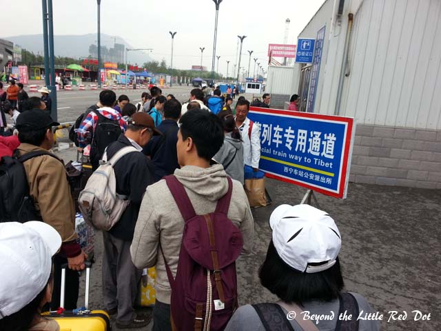 Queuing up to enter the train station. Security is very strict in letting only passengers with valid tickets through.