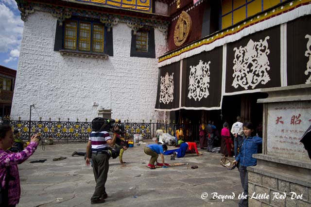 Pilgrims prostrating themselves in prayer.