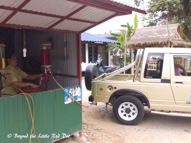 Filling up the tank of the rental jeep.