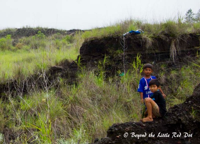 The children were playing while their parents did the farming.