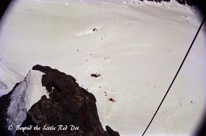 Some rich tourists taking a helicopter up and skiing down. 