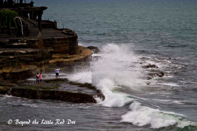 Tourists risking their lives to get that wave breaking shot.