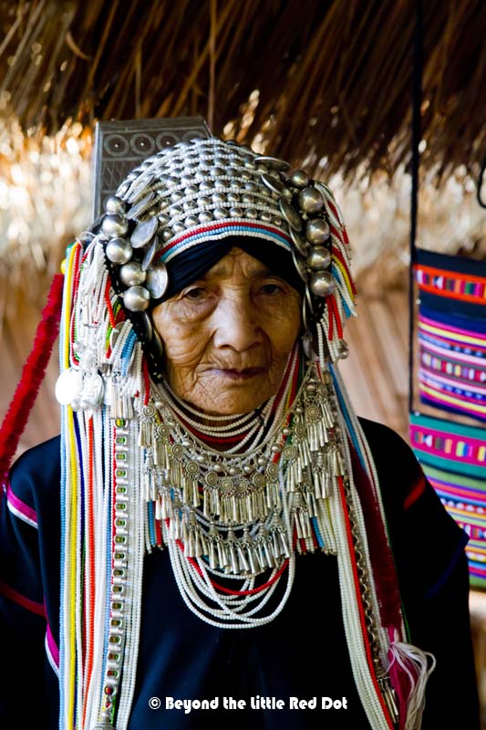 An Akha hill tribe woman and her very elaborate head dress. The style and design of the head dress defines her age and marital status.