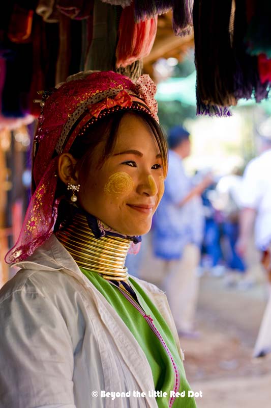 A younger woman with shorter neck rings.