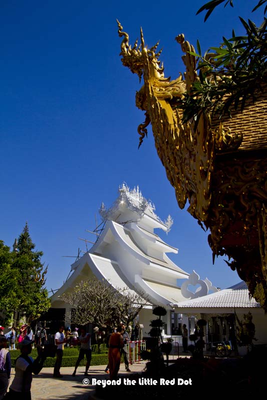 White and gold. The temple grounds are crowded with visitors.