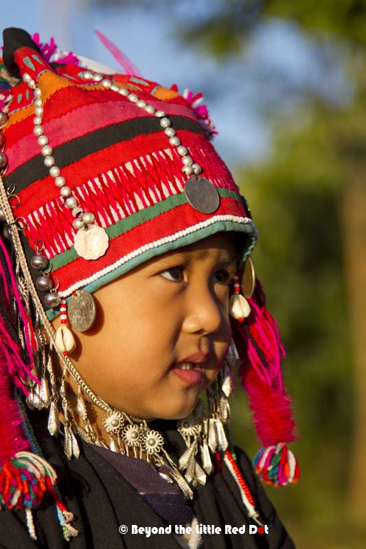 An Akha child in her traditional dress.