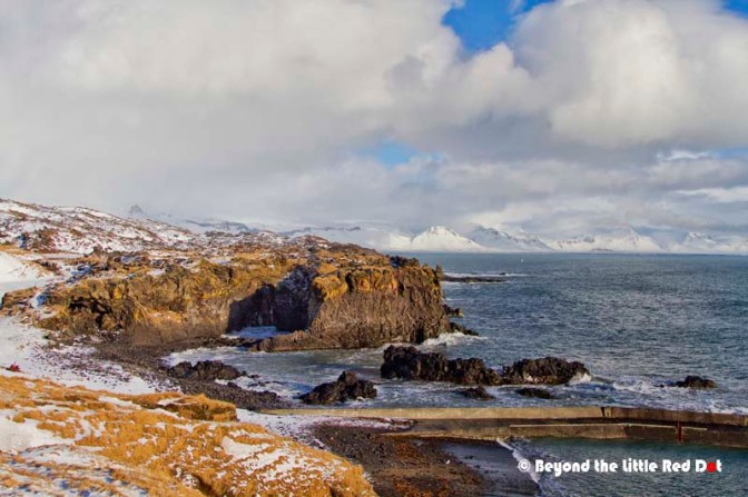 The coast at Hellnar with rock arches and sea cliffs.