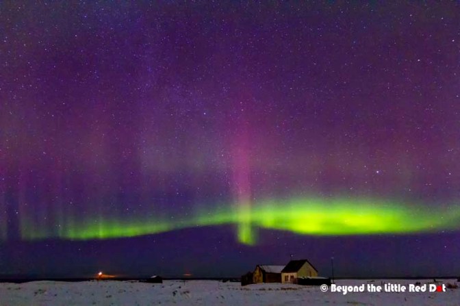 A zoomed in shot of a farmhouse. Our naked eyes could only see the green lights. The purple lights appeared in the photo.