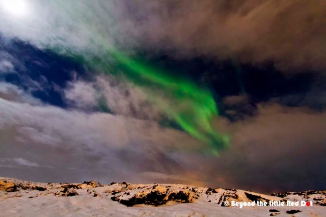 Cloudy skies doesn't mean all is lost. There are breaks in the clouds where you can still see the Aurora.