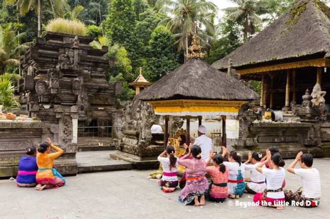 A priest leading a prayer ceremony away from the tourist crowds.